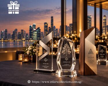 Premium customised trophies in crystal, acrylic and wood with engraved recipient names and logos, displayed at a Singapore awards event